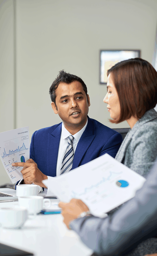 Two colleagues sitting at a table reviewing data.