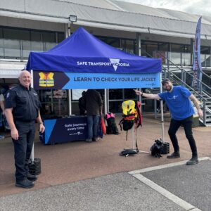 Photo shows the ST Vic stand at the National 4x4 show, with staff members in front of the lifejacket demonstration sign