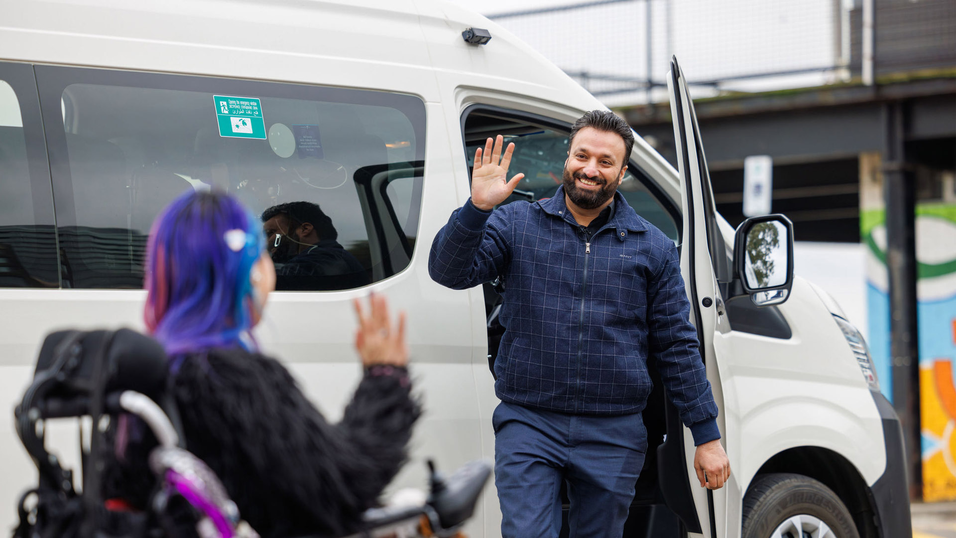 driver and passengers greeting each other outside a WAV vehicle